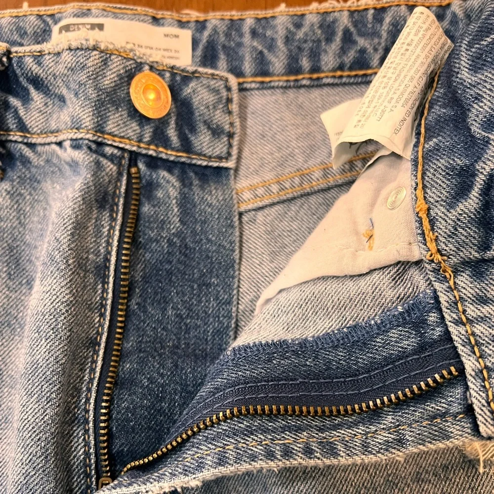 Bershka mom jeans high rise.  with rip in blue. Busted knee Size 4